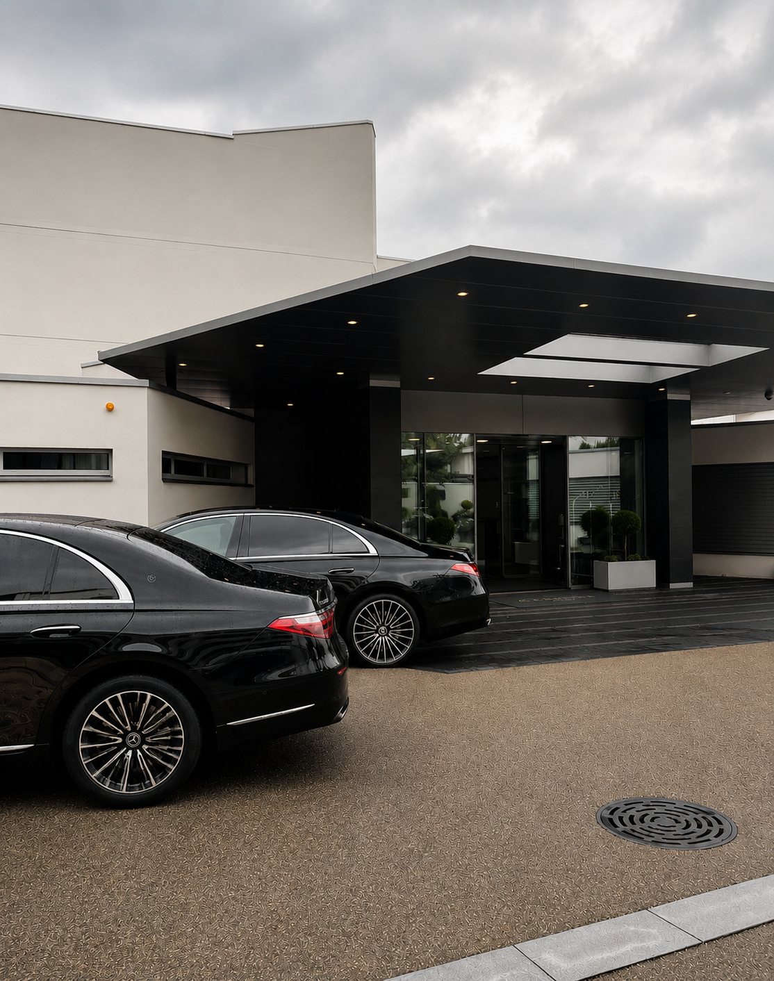 Mercedes S-Class at a corporate building entrance