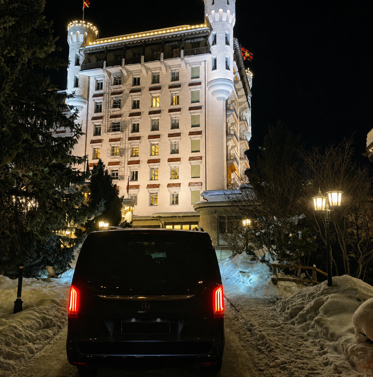 Mercedes V-Class at a grand alpine hotel at night